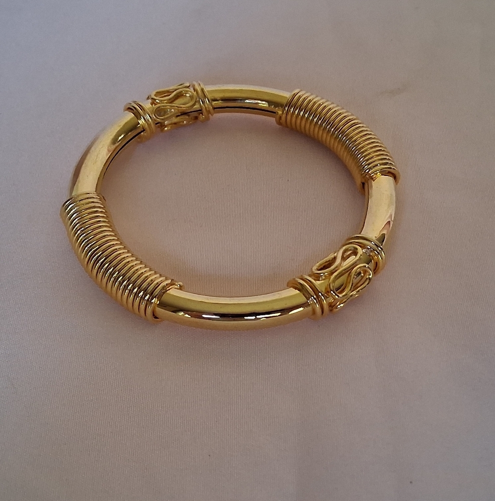 Gold Toned Egyptian Themed Bangle Bracelet Coil Accents And Upraised Designs
